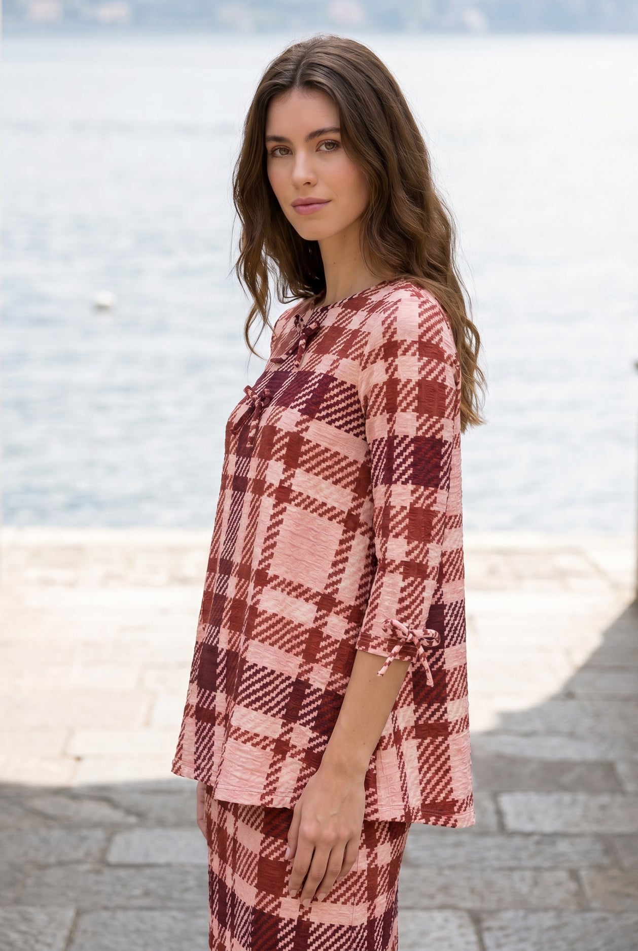 Model wearing Nuggles® Lexi Bow Top in Berry Paid