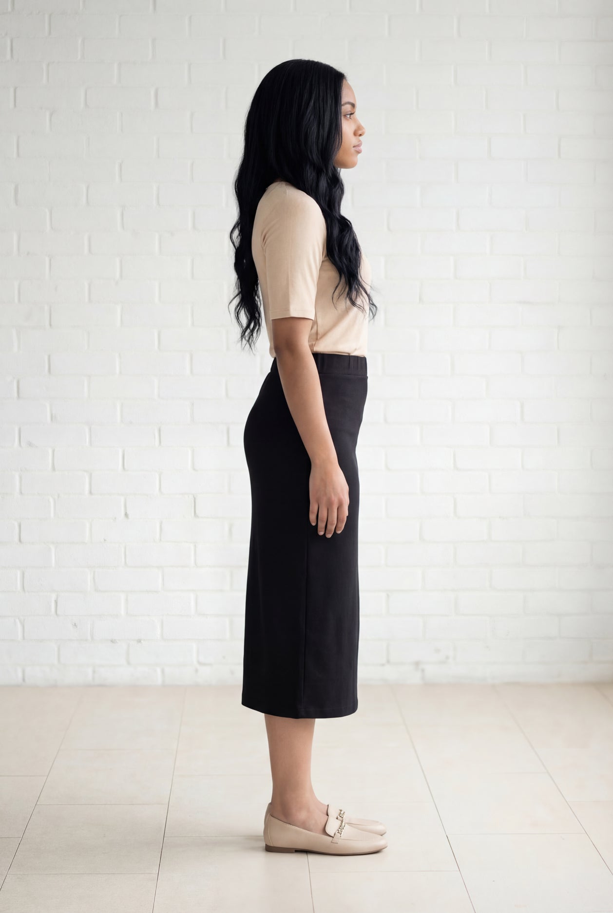 Model wearing Nuggles® 31" Relaxed Midi Skirt in Black