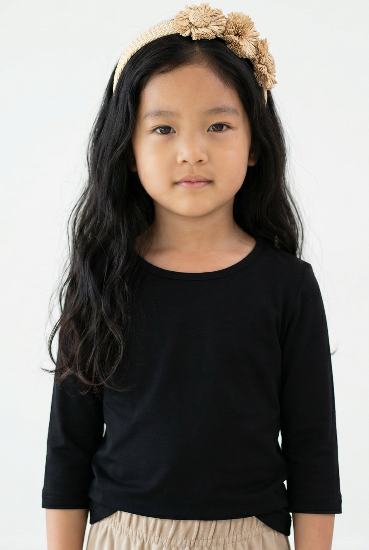 Model wearing the Girls' Nuggles® Essential 3/4 Tee in Black