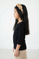 Model wearing the Girls' Nuggles® Essential 3/4 Tee in Black