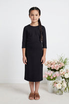 Model wearing Nuggles® Girls Midi Layering Dress in Black
