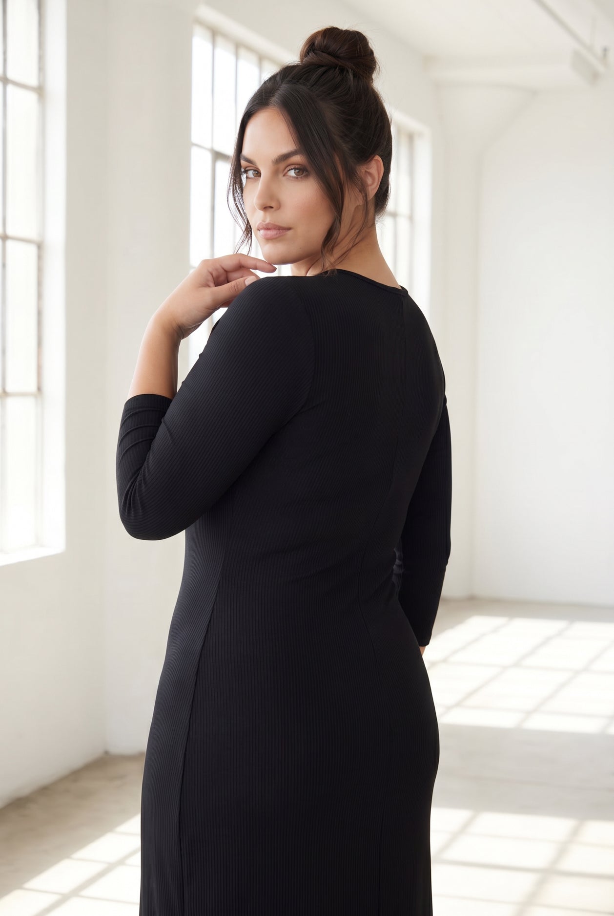 Model wearing Nuggles® Ribbed Midi Layering Dress in Black