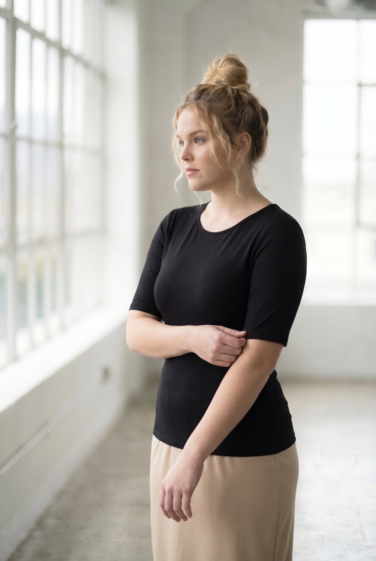 Model wearing the Nuggles® Essential Half Sleeve Tee in Black