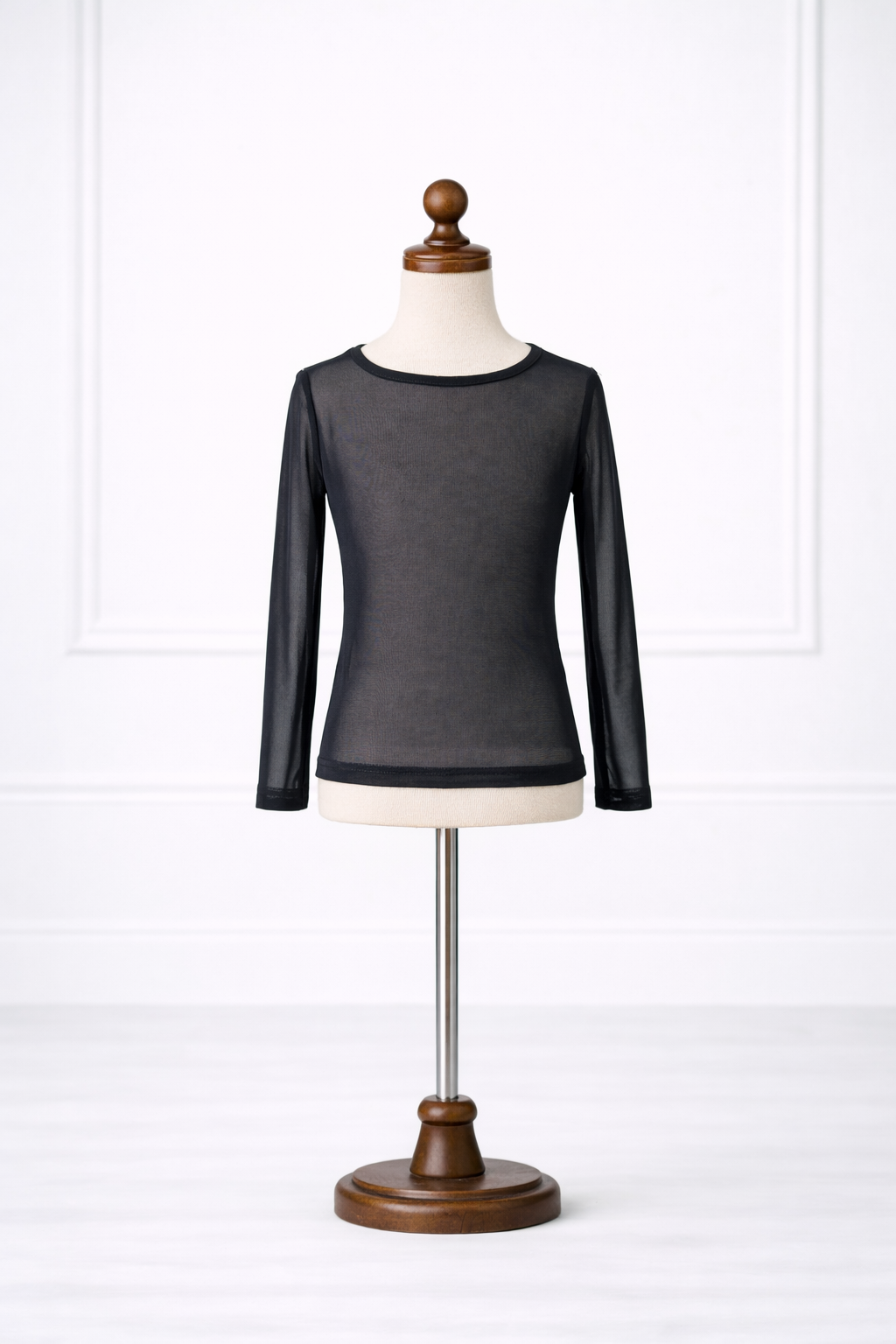 Black long-sleeve shirt on a mannequin against a white background
