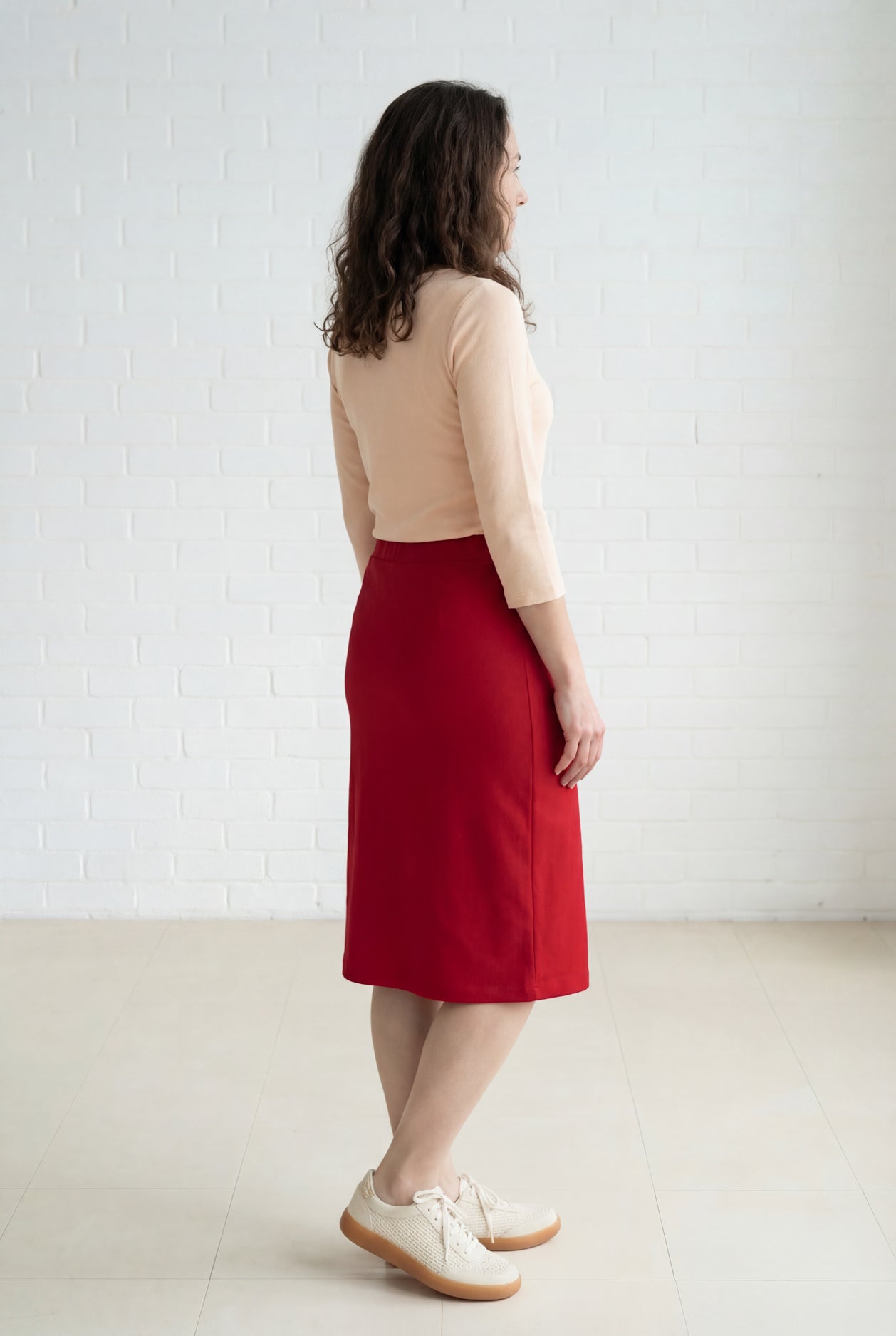 Model wearing Nuggles® 27" Relaxed Midi Skirt in Brick Red