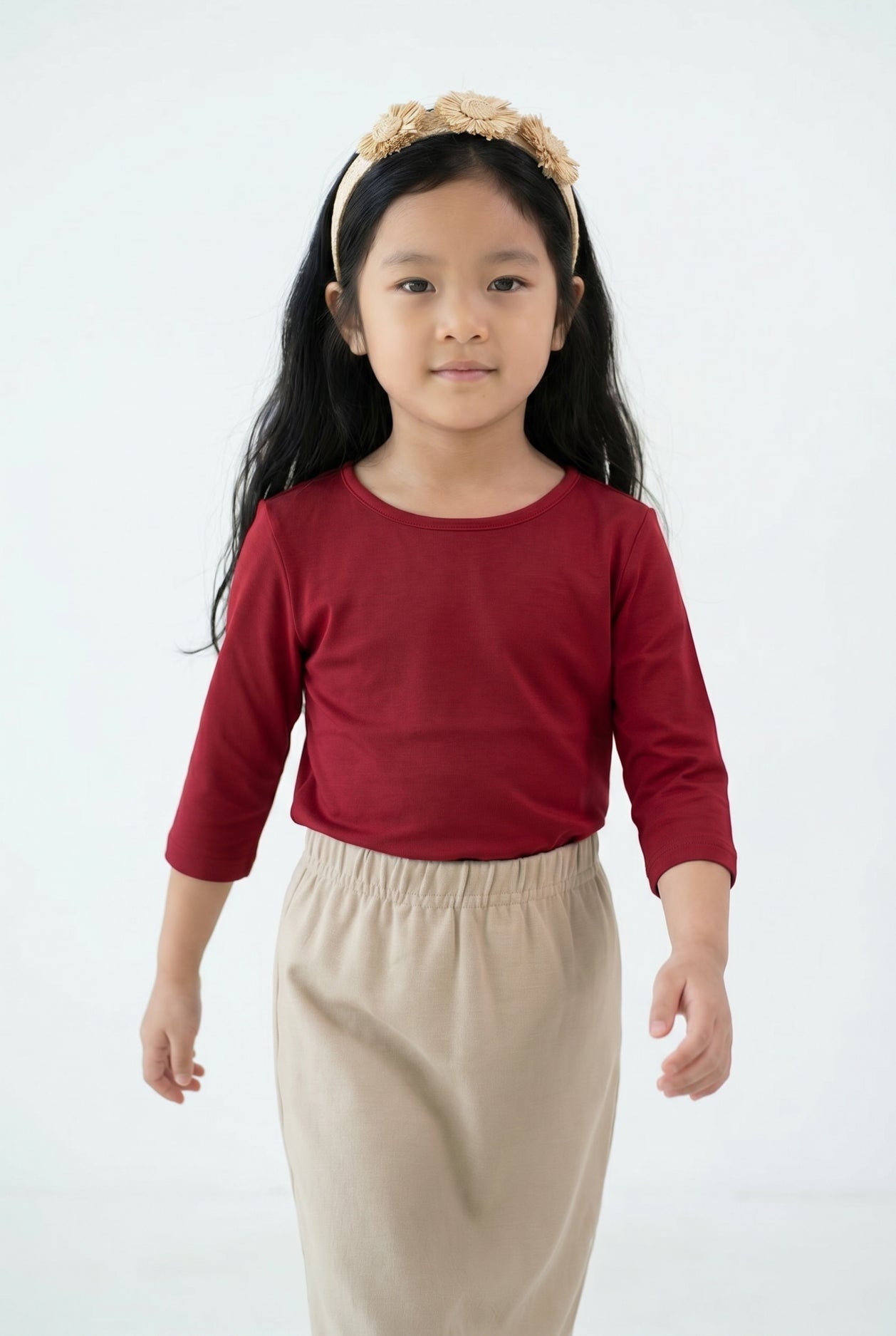 Model wearing the Girls' Nuggles® Essential 3/4 Tee in Brick Red