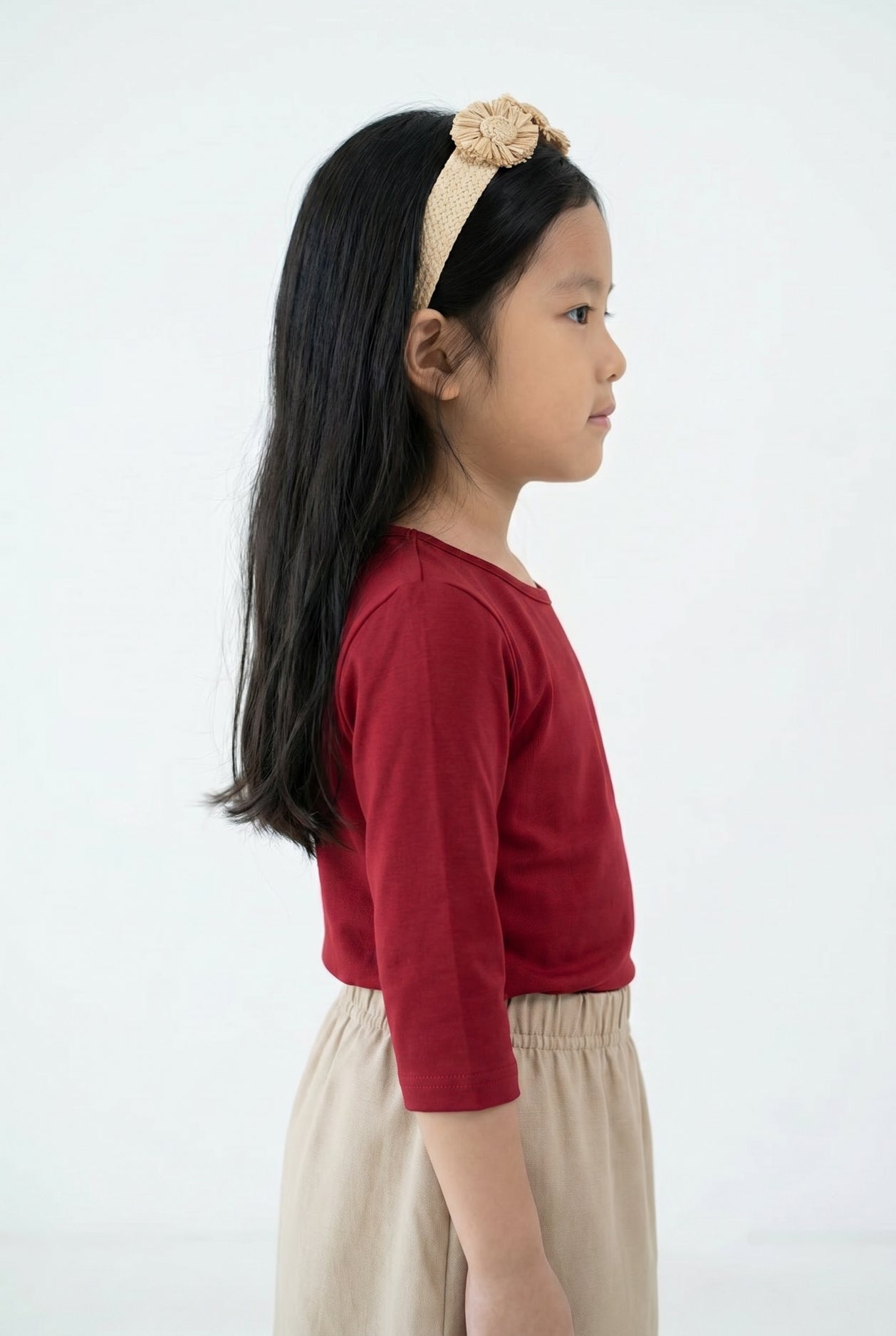 Model wearing the Girls' Nuggles® Essential 3/4 Tee in Brick Red