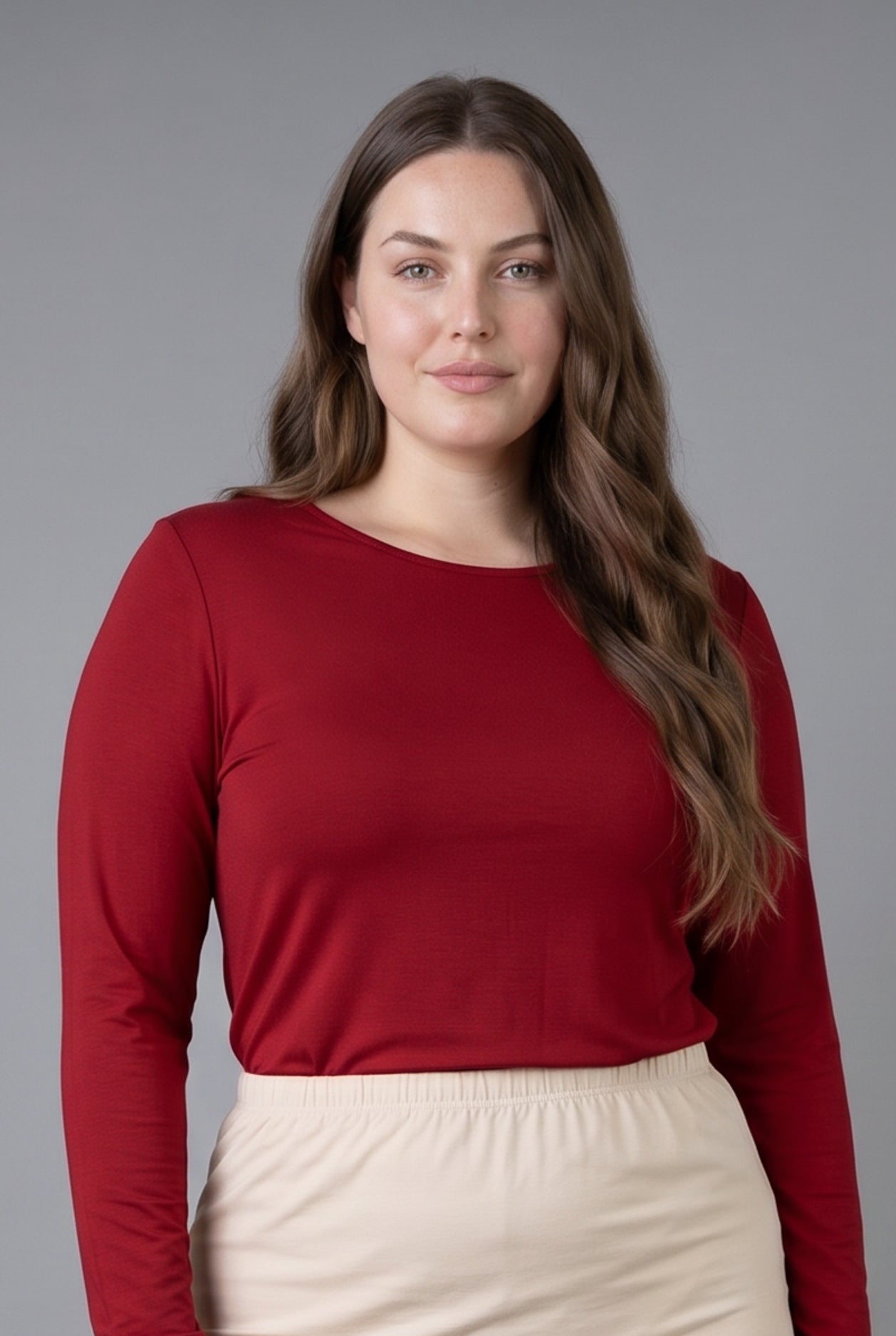 Model wearing Nuggles® Long Sleeve Essential Tee in Brick Red