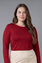 Model wearing Nuggles® Long Sleeve Essential Tee in Brick Red