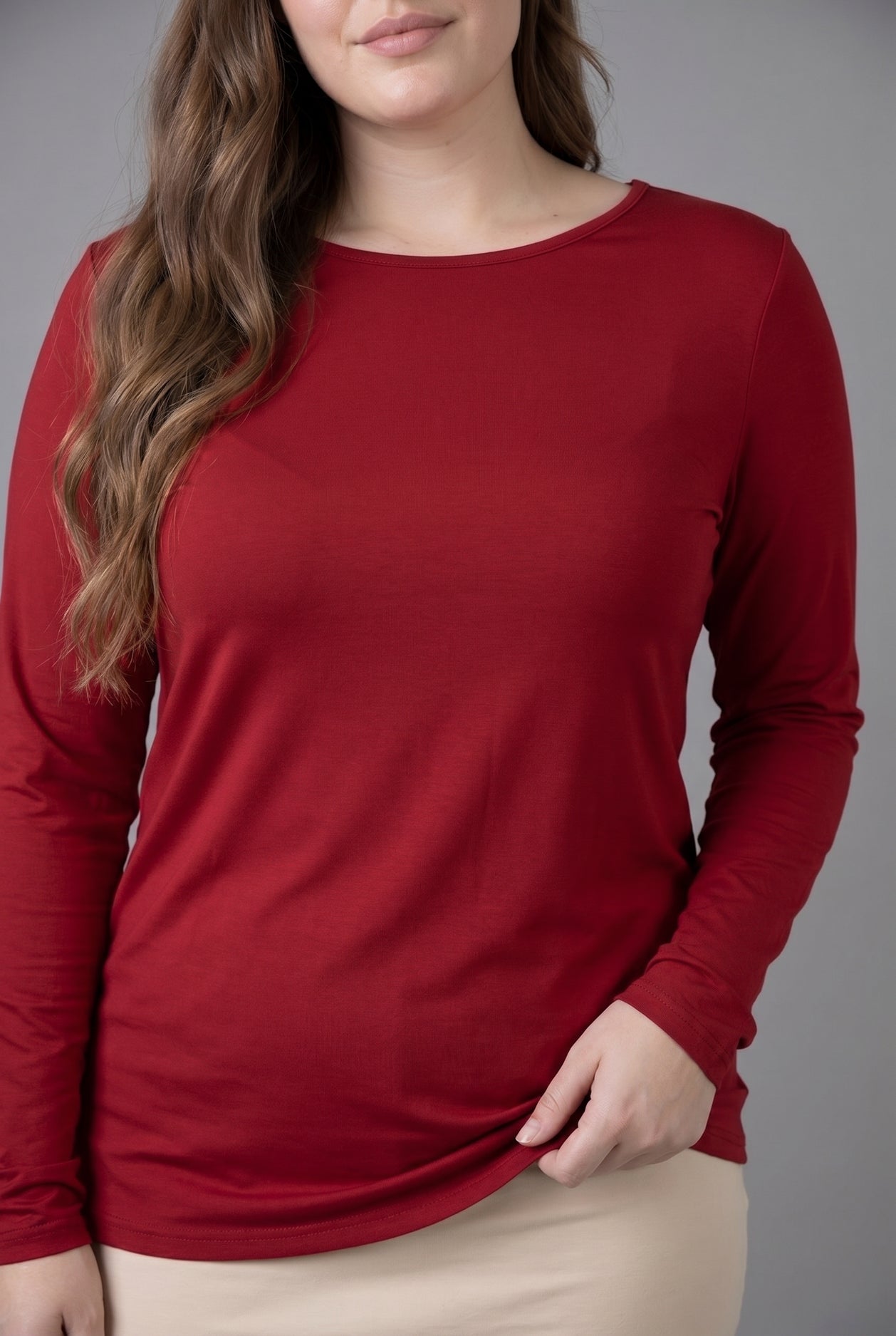 Model wearing Nuggles® Long Sleeve Essential Tee in Brick Red