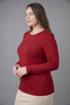 Model wearing Nuggles® Long Sleeve Essential Tee in Brick Red