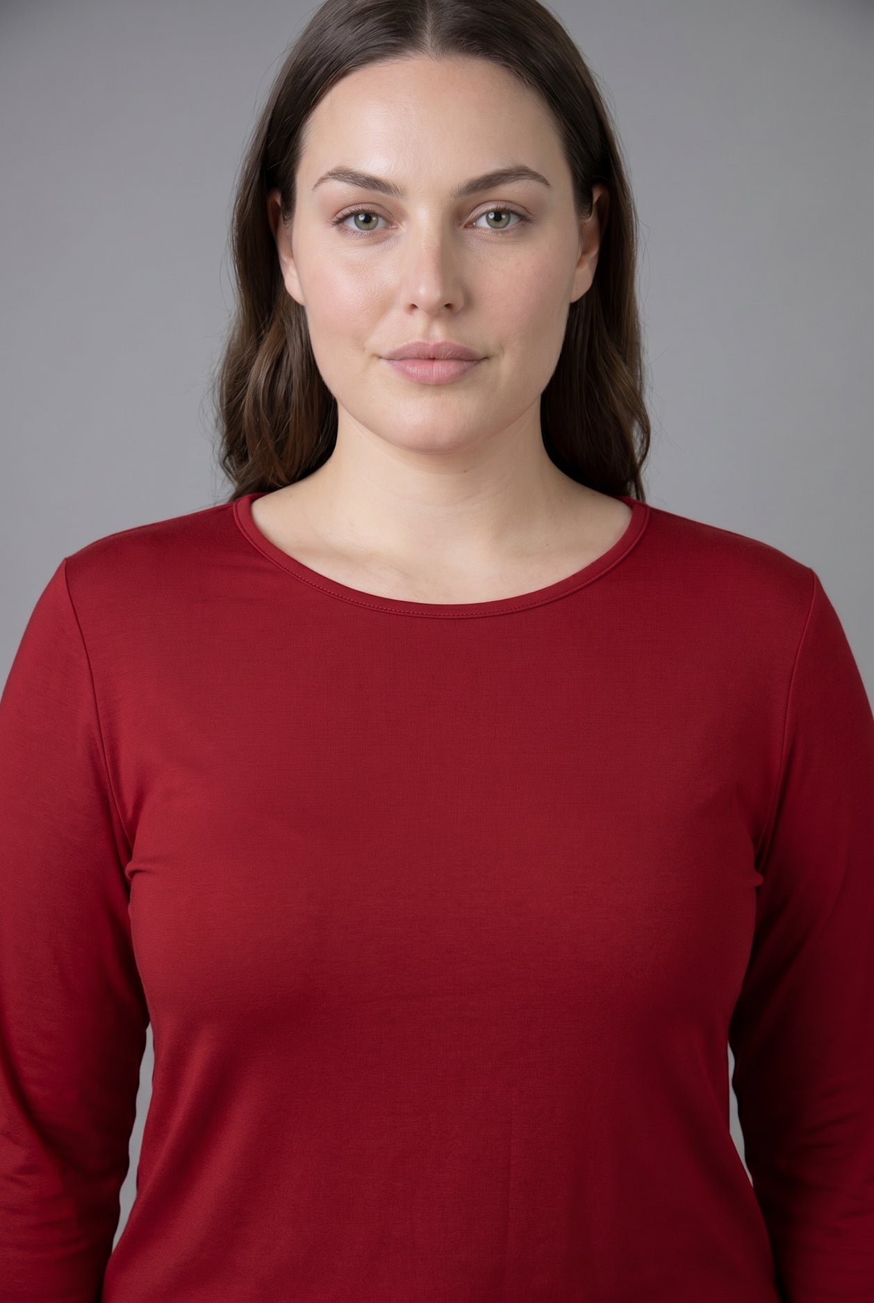 Model wearing Nuggles® Long Sleeve Essential Tee in Brick Red