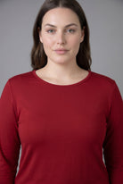Model wearing Nuggles® Long Sleeve Essential Tee in Brick Red