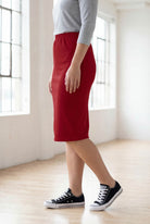 Model wearing Nuggles® 25" Classic Skirt  in Brick Red