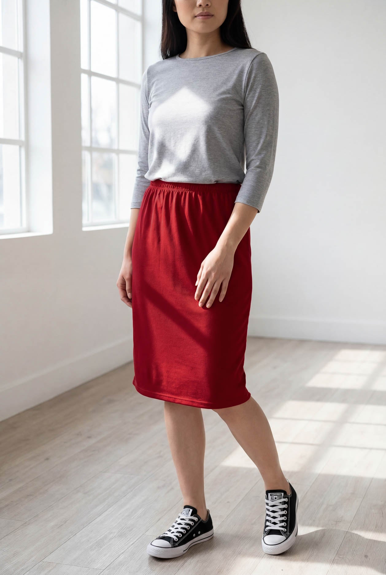 Model wearing Nuggles® 25" Classic Skirt  in Brick Red
