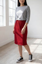 Model wearing Nuggles® 25" Classic Skirt  in Brick Red