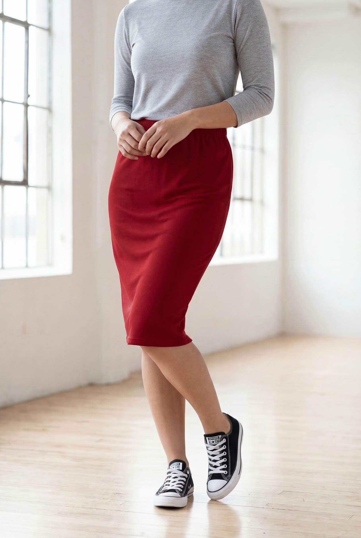 Model wearing Nuggles® 25" Classic Skirt  in Brick Red