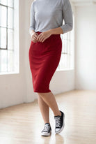Model wearing Nuggles® 25" Classic Skirt  in Brick Red