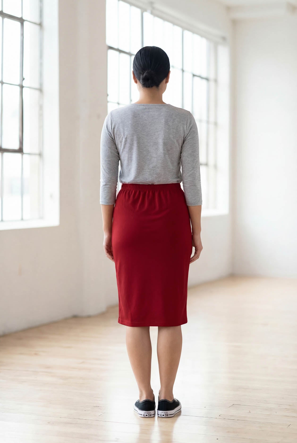 Model wearing Nuggles® 25" Classic Skirt  in Brick Red