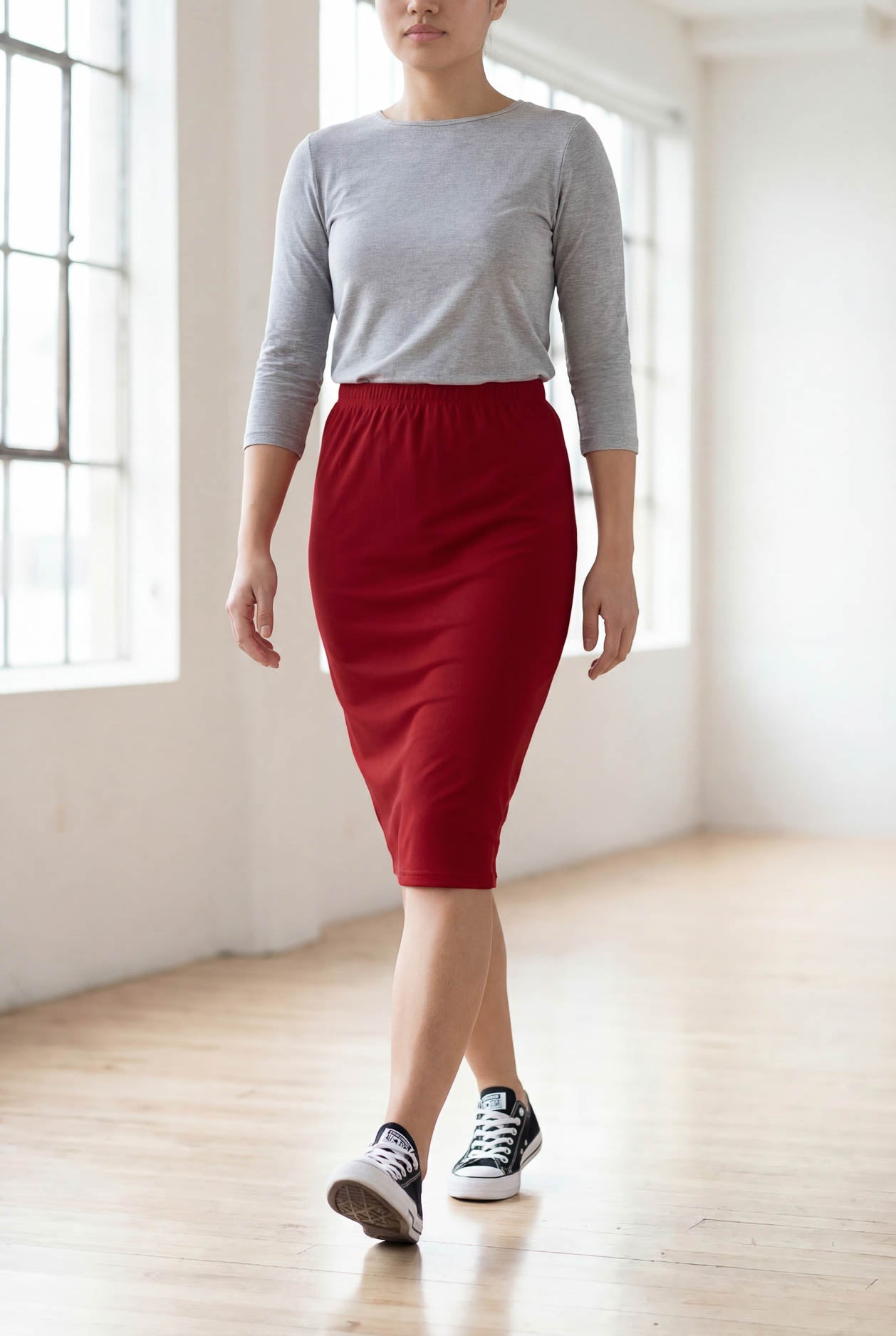 Model wearing Nuggles® 25" Classic Skirt  in Brick Red
