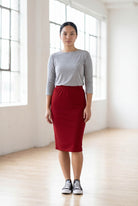 Model wearing Nuggles® 25" Classic Skirt  in Brick Red