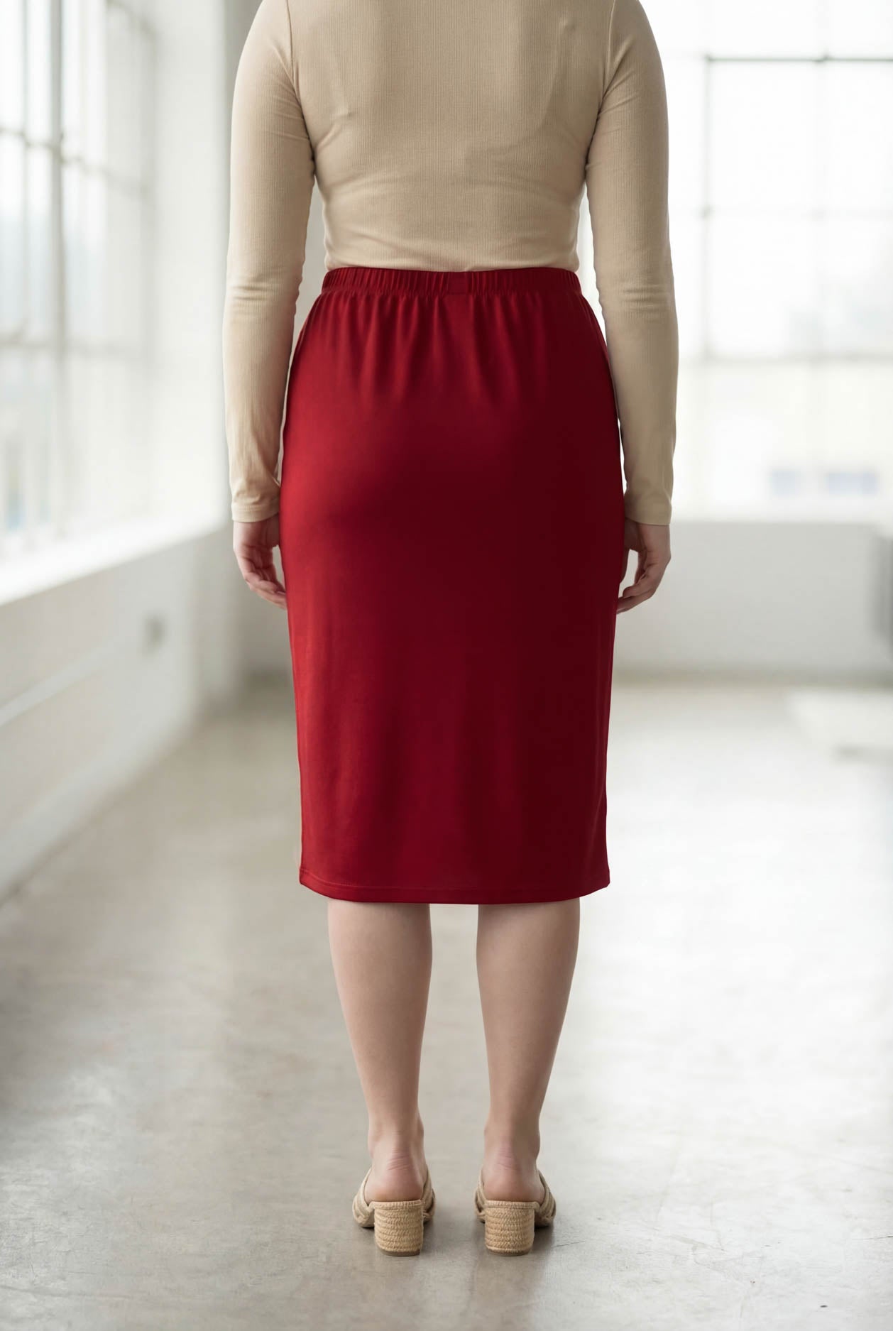 Model wearing Nuggles® 27" Classic Skirt  in Brick Red