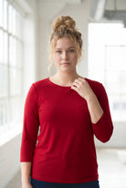 Model wearing Nuggles® 3/4 Essential Tee in Brick Red