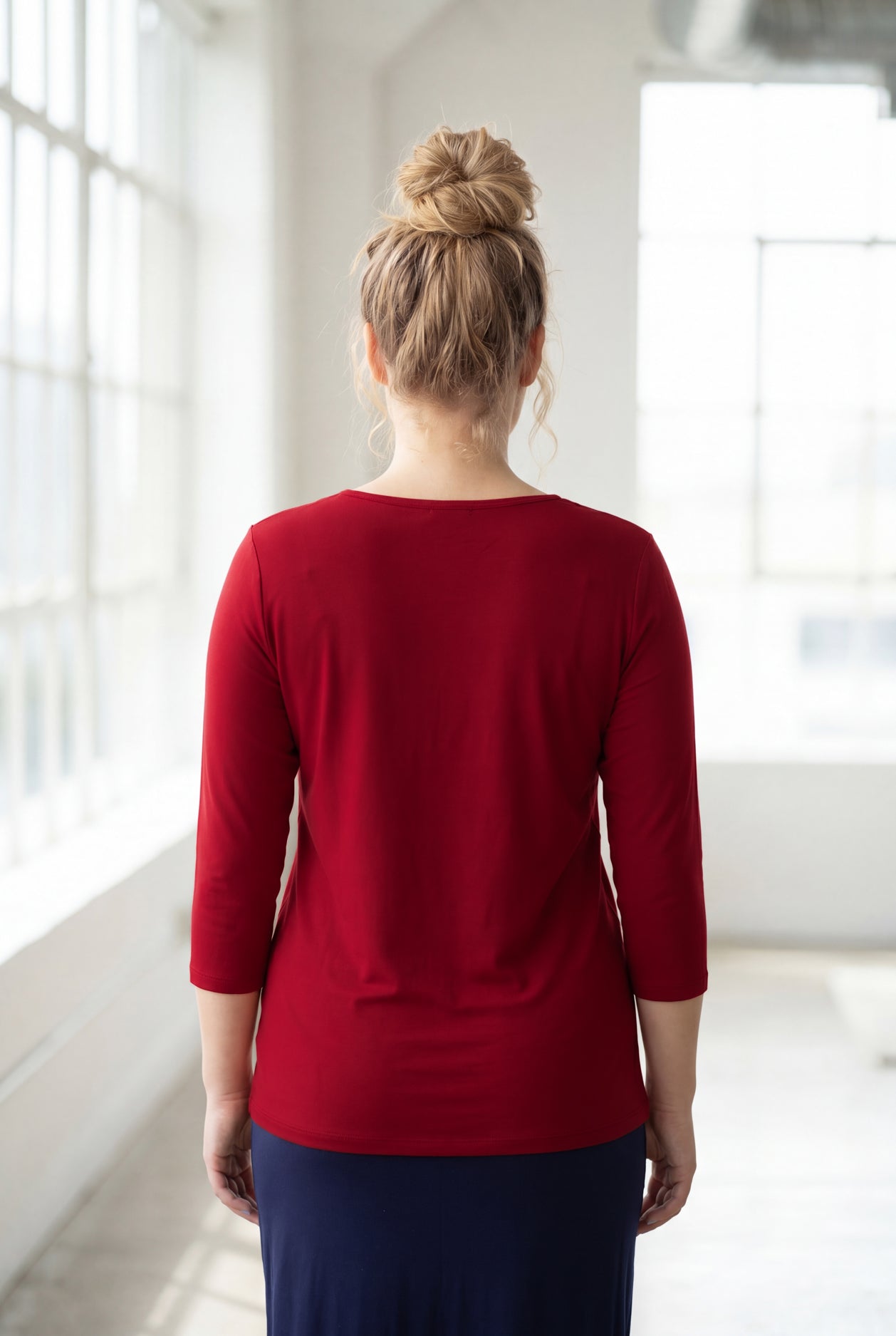 Model wearing Nuggles® 3/4 Essential Tee in Brick Red
