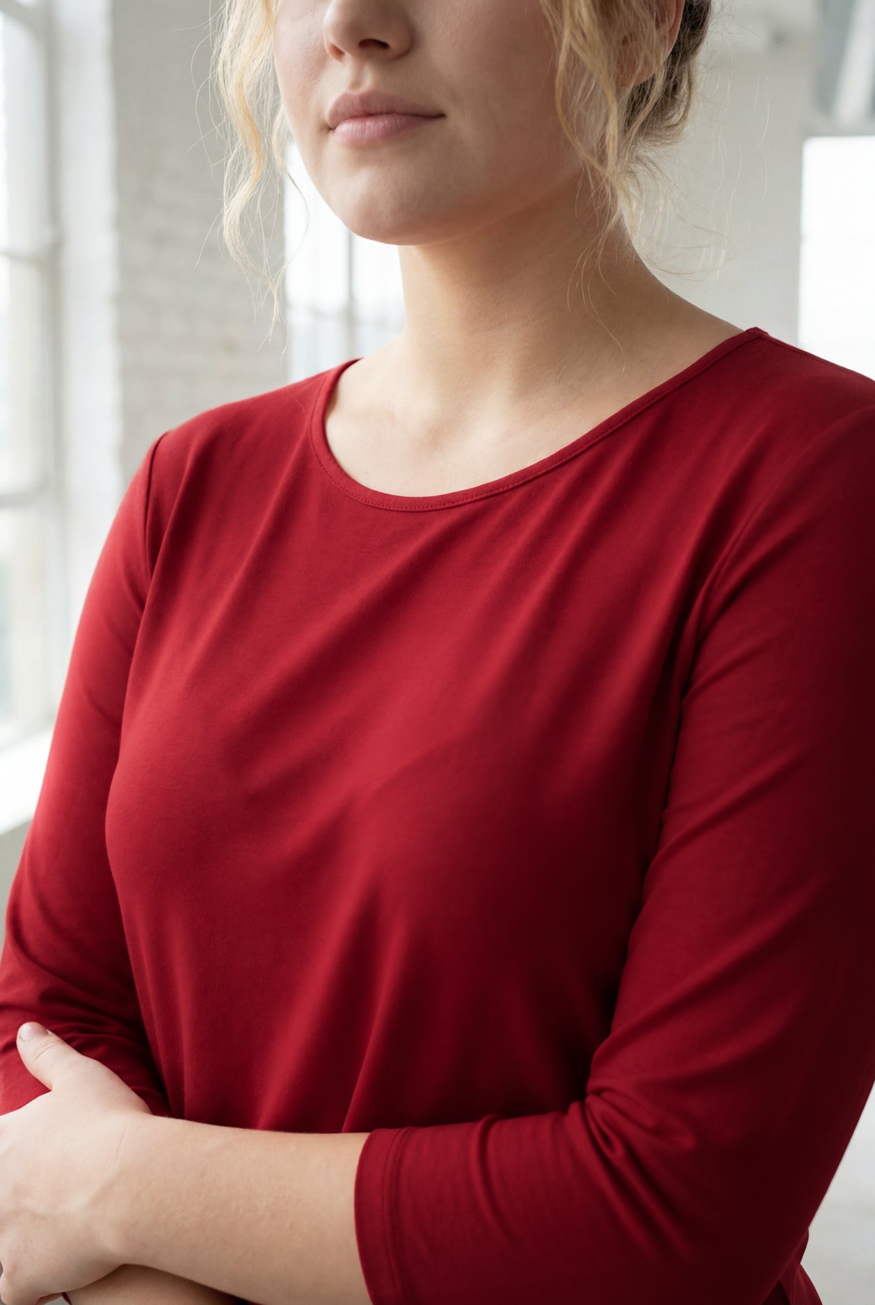Model wearing Nuggles® 3/4 Essential Tee in Brick Red