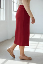 Model wearing Nuggles® 31" Classic Skirt  in Brick Red
