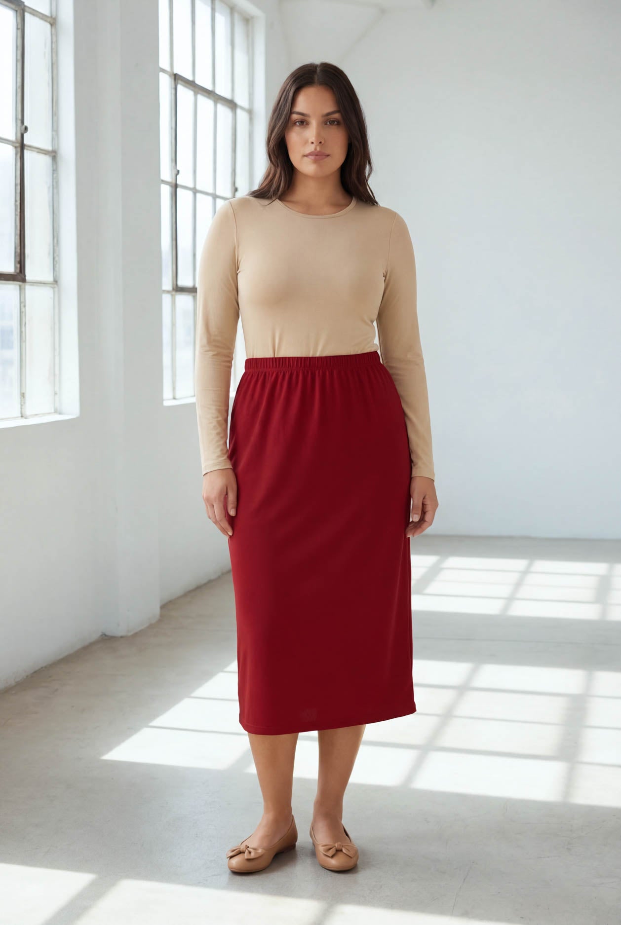 Model wearing Nuggles® 31" Classic Skirt  in Brick Red