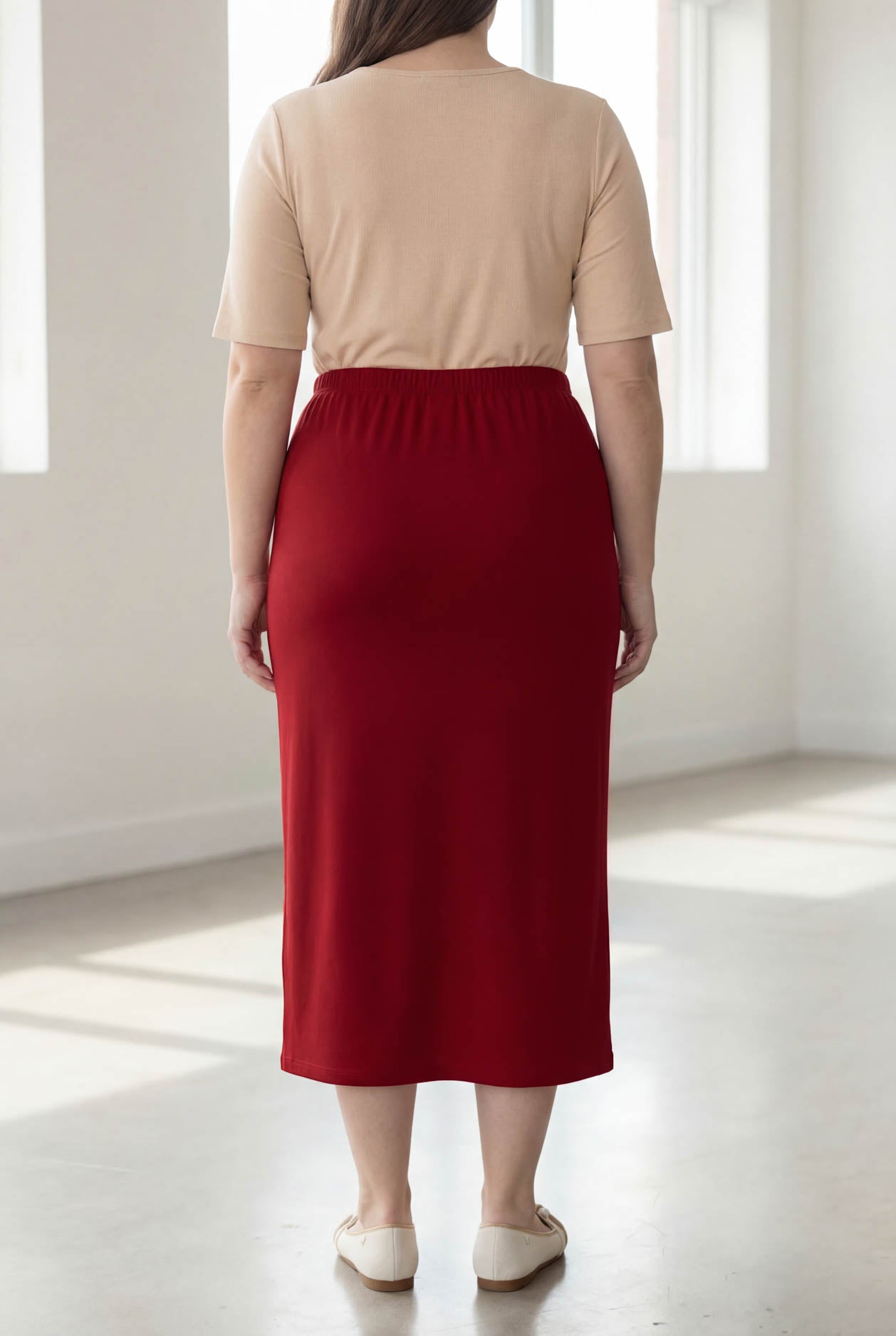Model wearing Nuggles® 34" Classic Skirt  in Brick Red