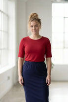 Model wearing the Nuggles® Essential Half Sleeve Tee in Brick Red