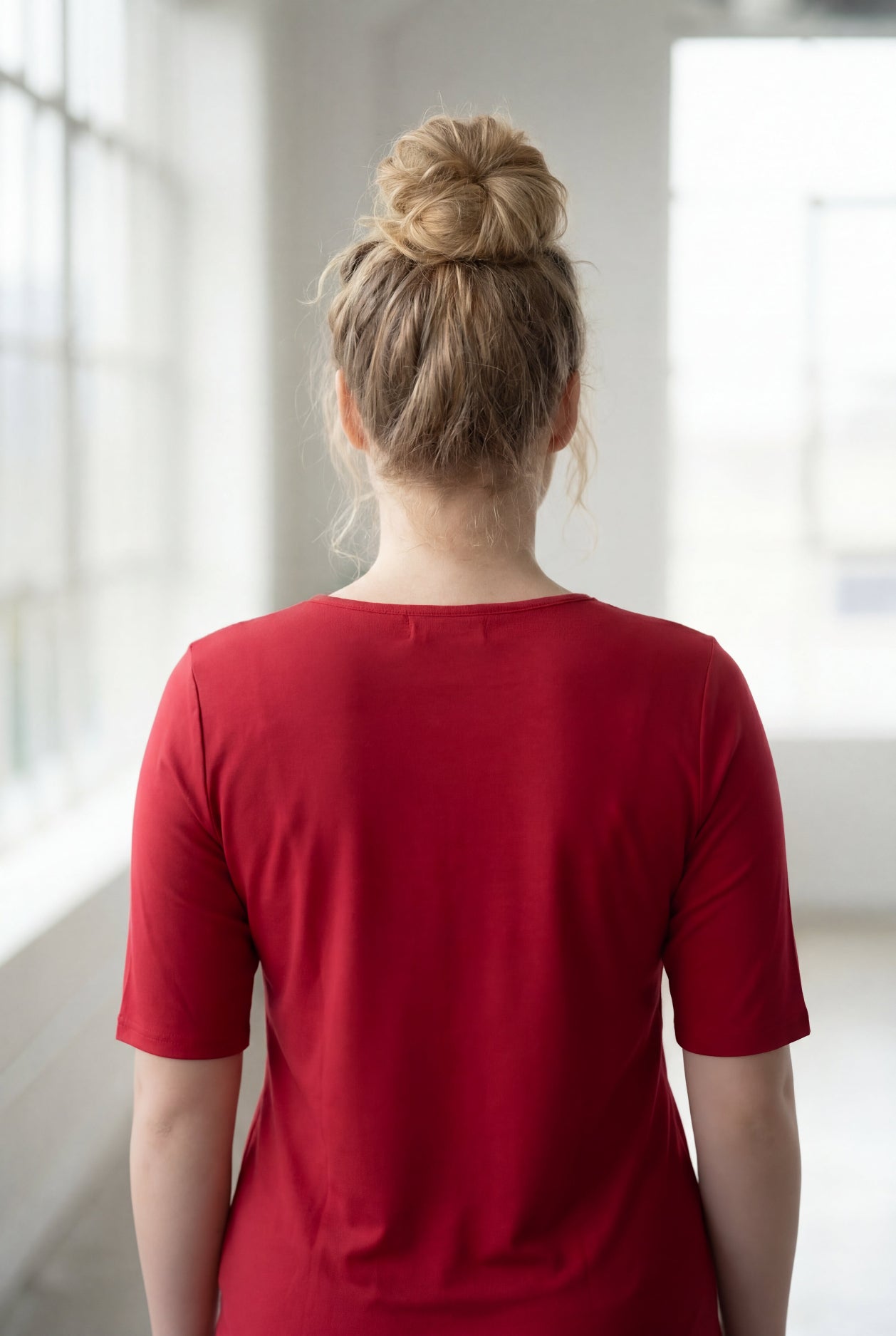 Model wearing Nuggles® Half Sleeve Essential Tee in Brick Red
