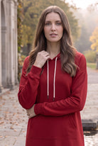Model wearing Nuggles®   Hoodie Dress in Brick Red