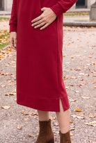 Model wearing Nuggles®   Hoodie Dress in Brick Red