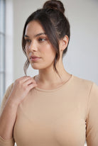 Model wearing Nuggles® 3/4 Essential Tee in Buff