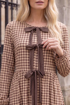 Model wearing Nuggles®  Addison Dress in Buffalo Check