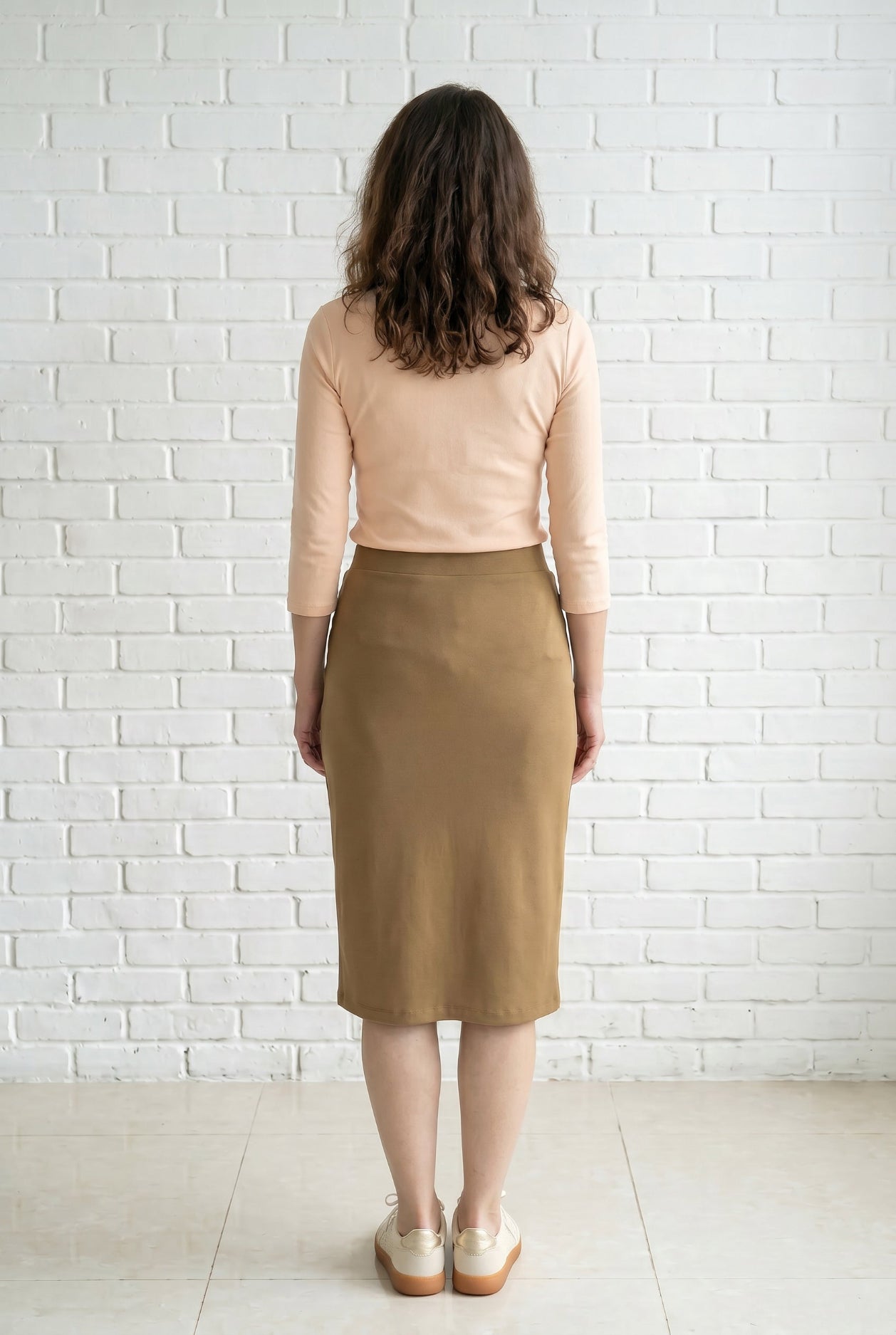 Model wearing Nuggles® 27" Relaxed Skirt in Camel