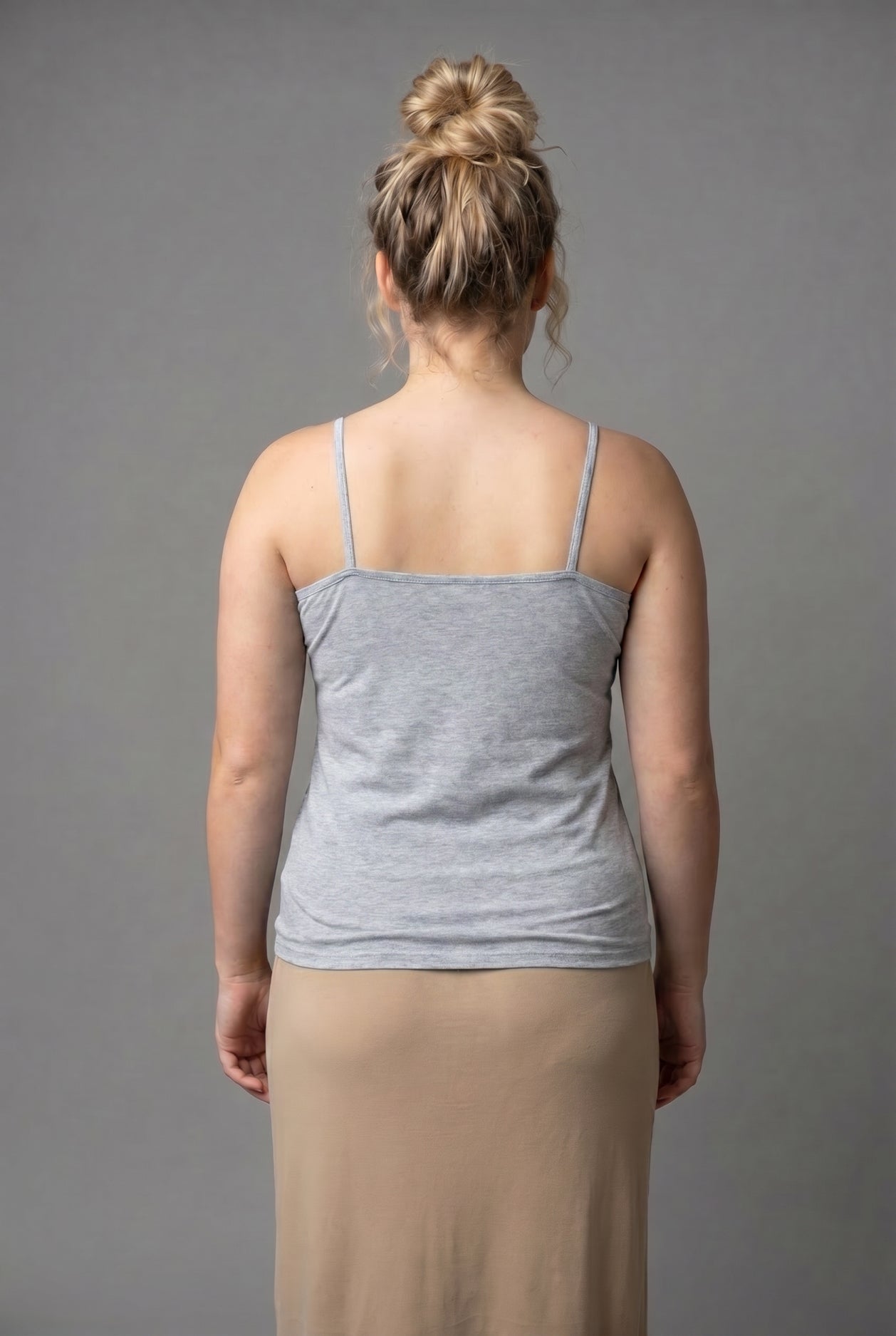 A photo of a women wearing a camisole in heather gray.
