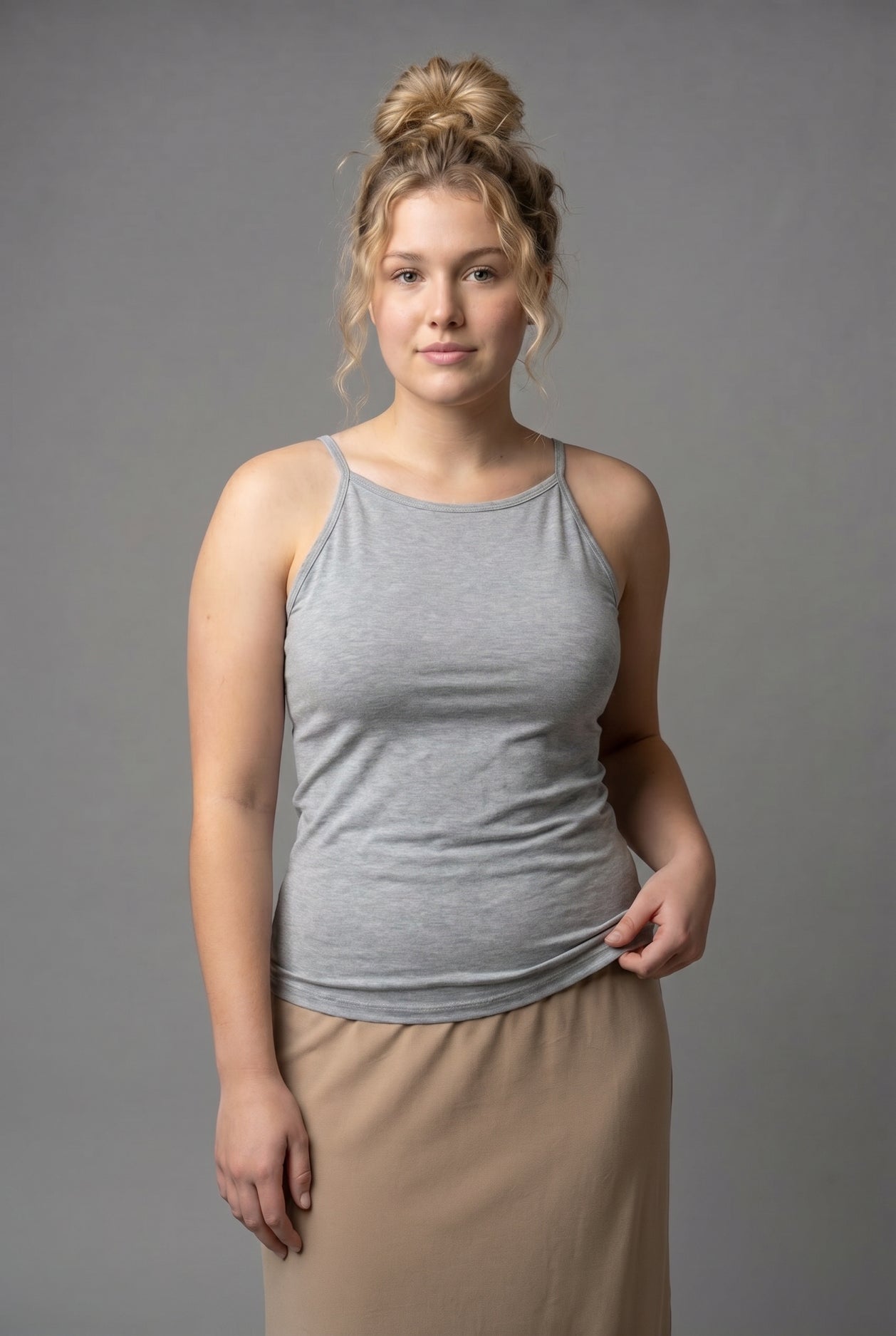 A photo of a women wearing a camisole in heather gray.
