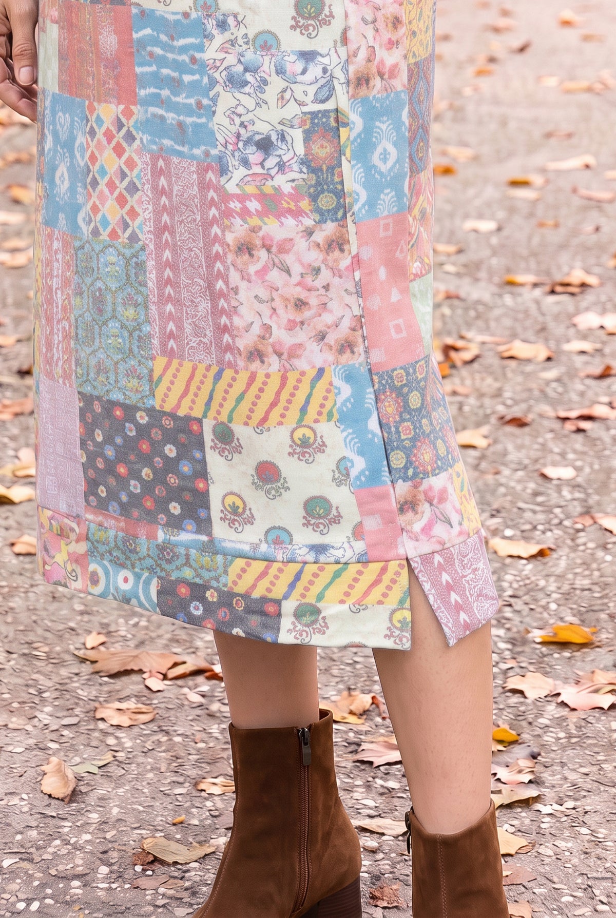Nuggles® Hoodie Dress in Candy Lane, close-up of the banded hem and side slit above brown boots