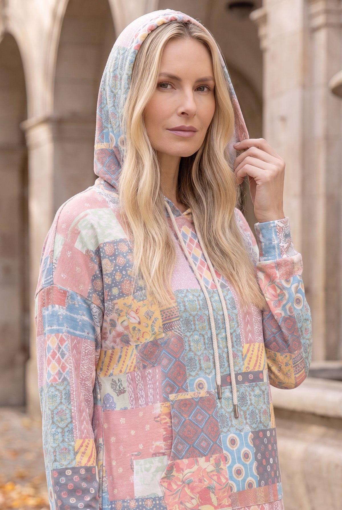 Nuggles® Hoodie Dress in Candy Lane worn with the hood up, showing the patchwork print scale