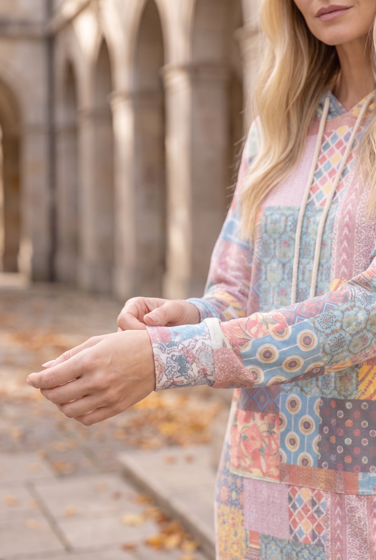 Nuggles® Hoodie Dress in Candy Lane, close-up of the sleeve cuff and patchwork print at the wrist
