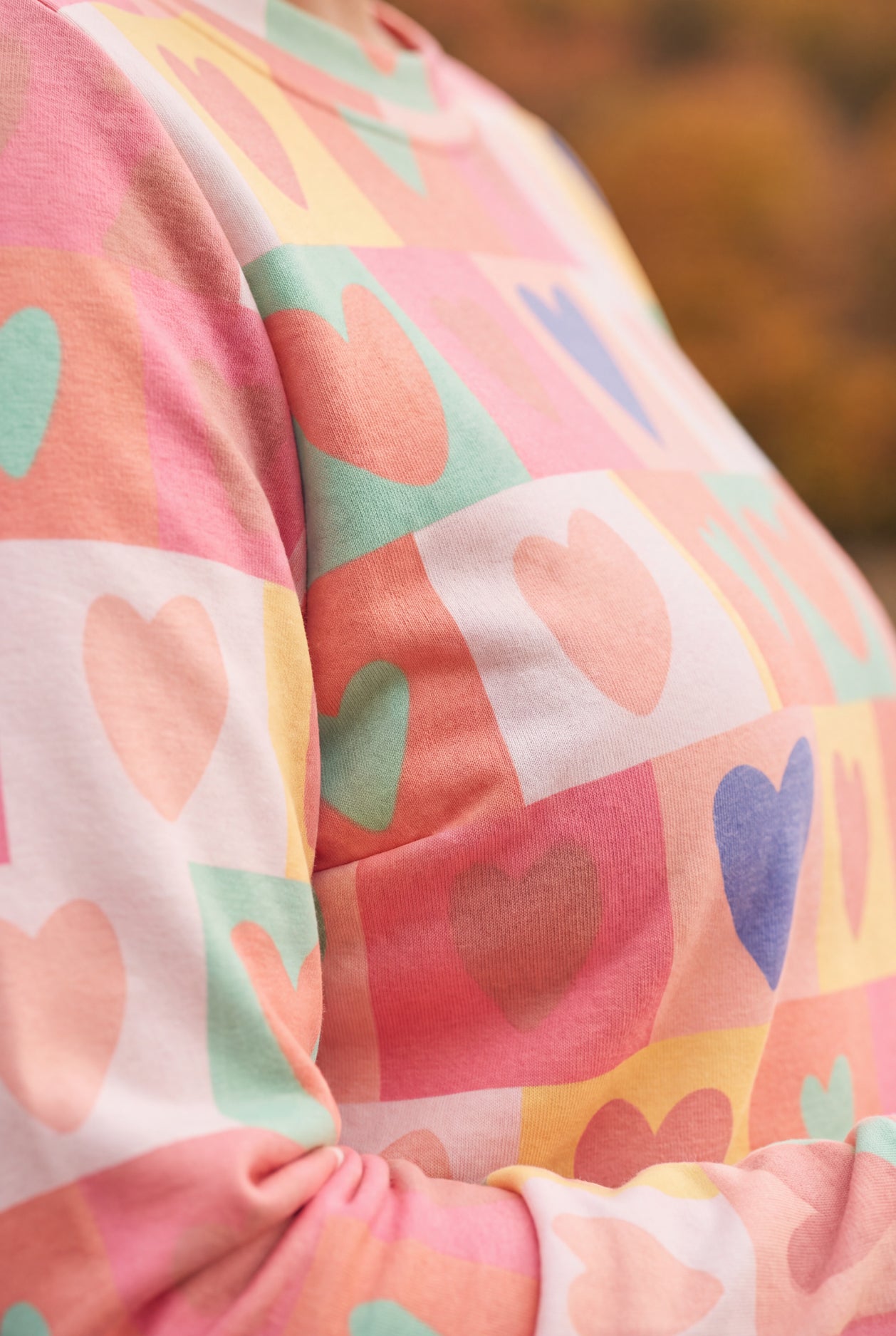 Model wearing Nuggles®  Iris Sweater Shirt in Candy Hearts