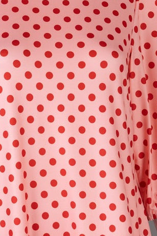 Nuggles® Patricia Dress in Cherry Dot, detail of the red dot print on coral with burgundy ruffle trim