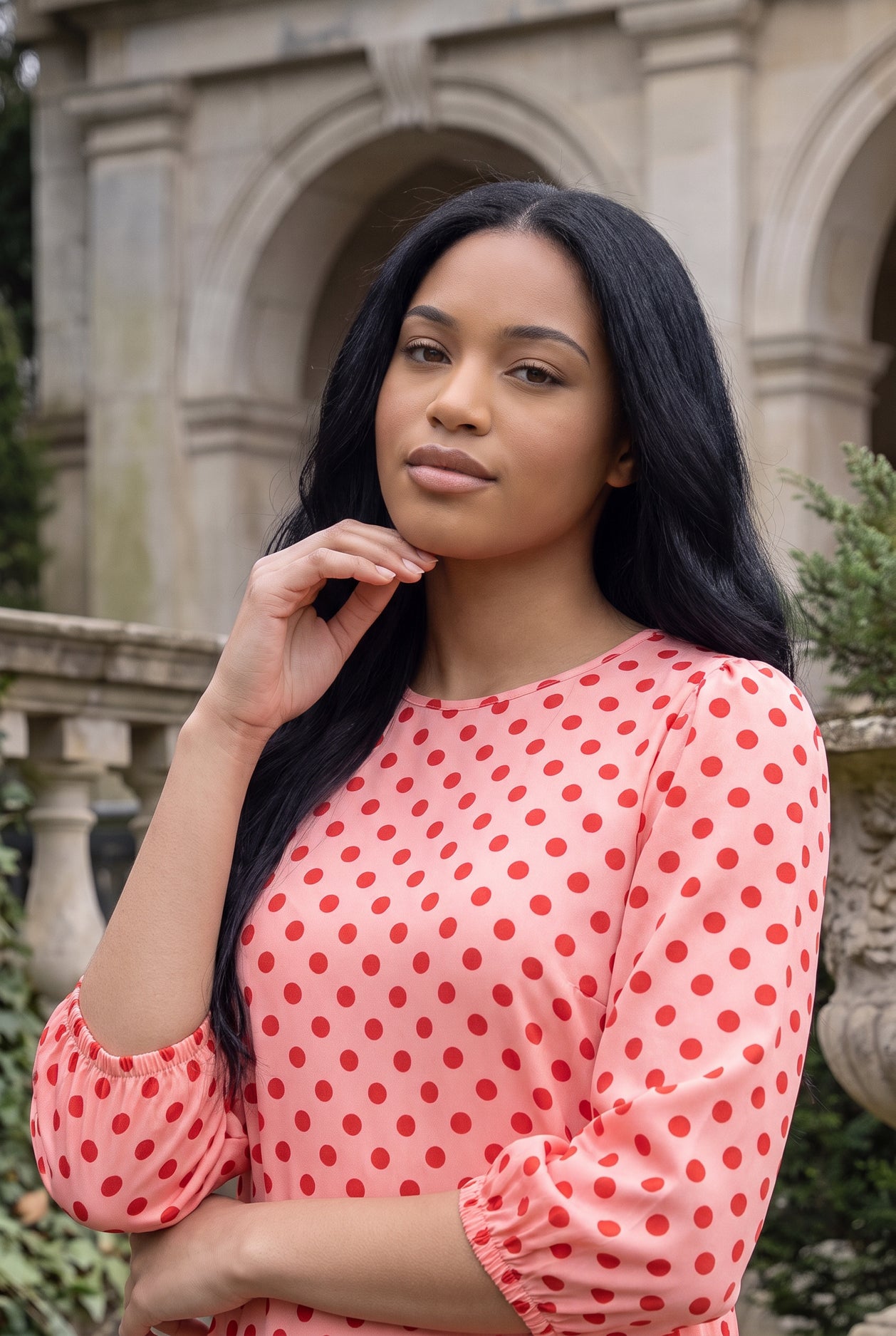 Nuggles® Patricia Dress in Cherry Dot, upper-body portrait showing the round neckline and red dot print