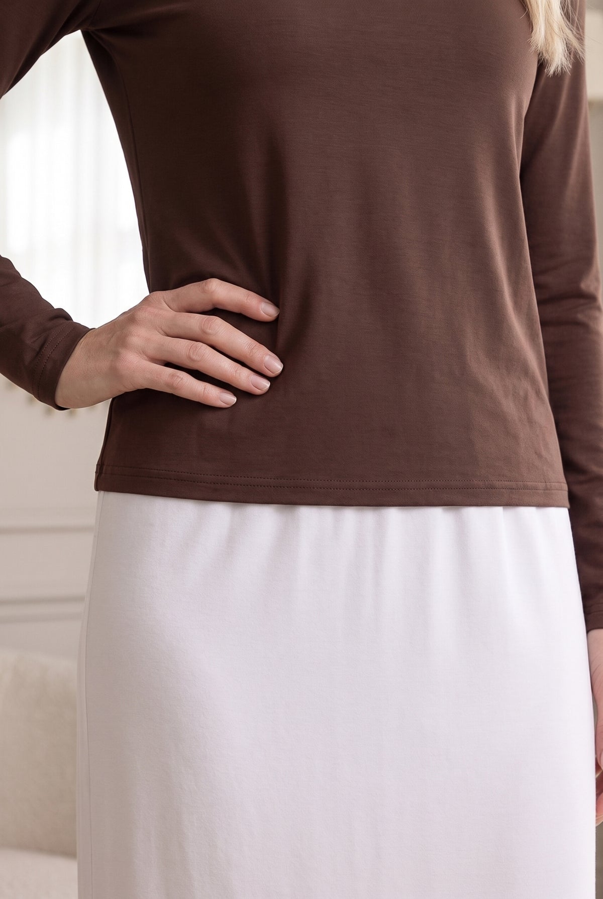Model wearing Nuggles®  Long Sleeve Essential Tee in Chocolate Brown