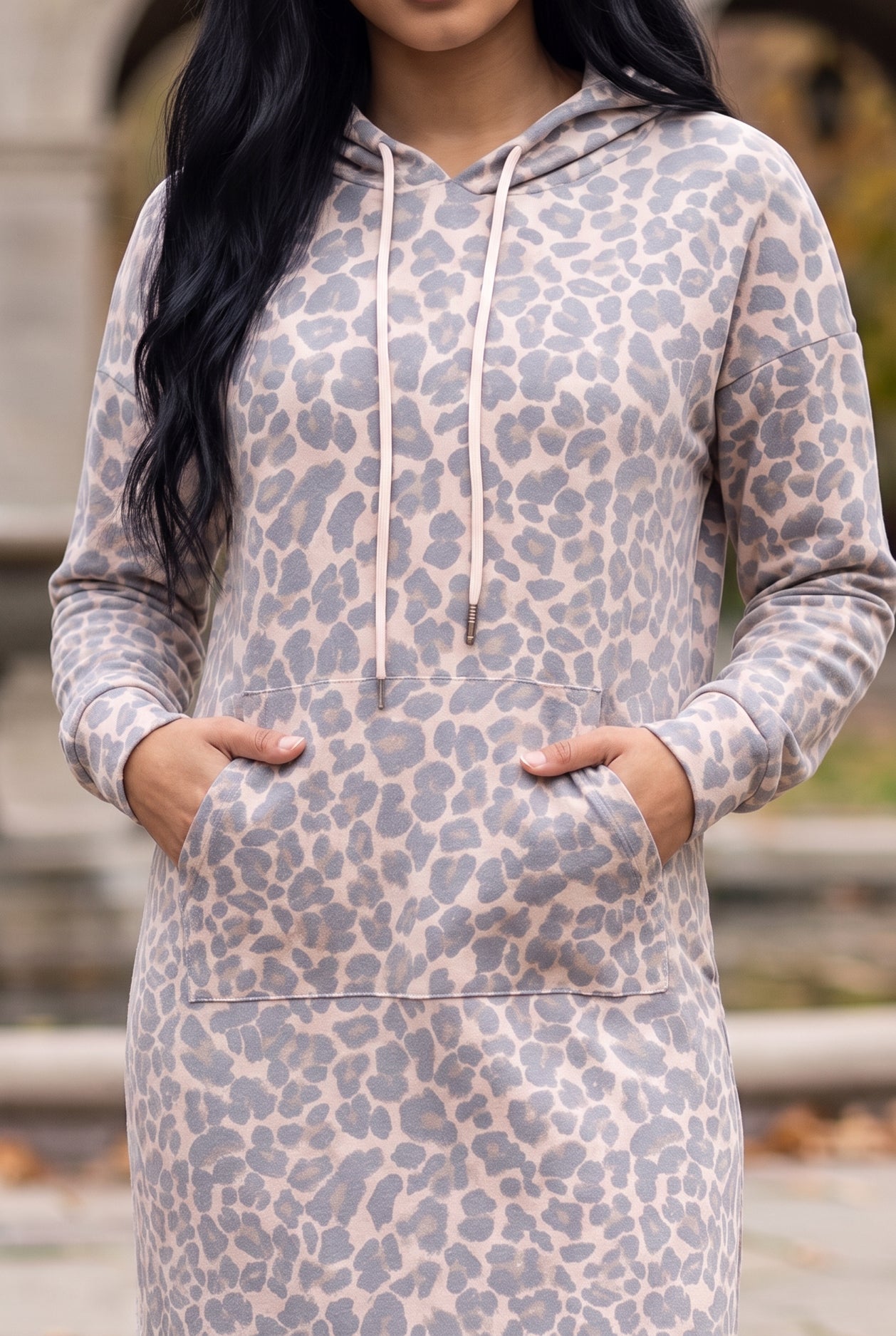 Nuggles® Hoodie Dress in Classic Leopard, both hands in the front kangaroo pocket