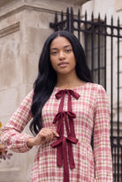 Model wearing Nuggles®  Addison Dress in Cranberry Paid